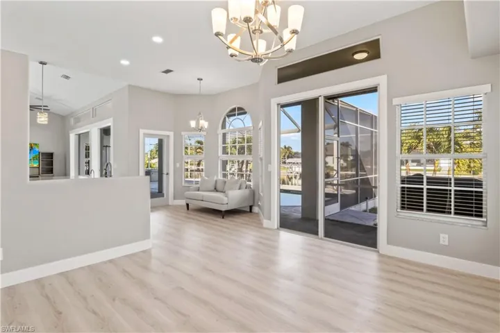 Dining space featuring a chandelier, light wood finished floors, plenty of natural light, and recessed lighting
