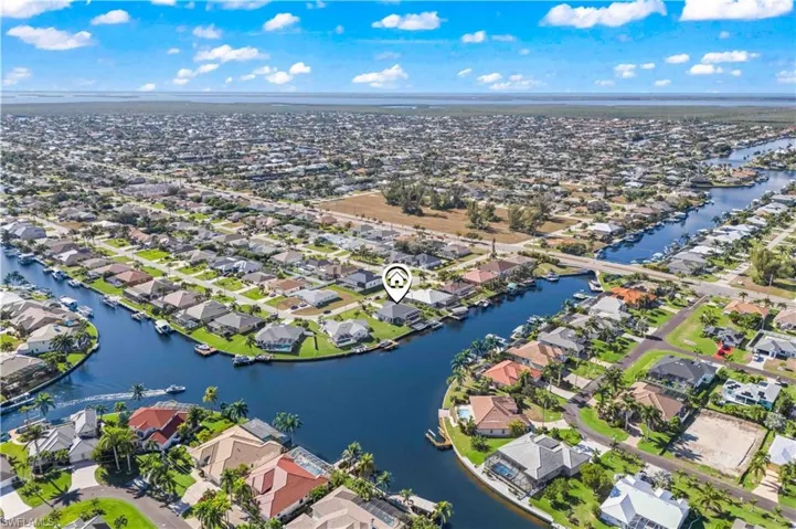 Aerial overview of property's location with nearby suburban area and a large body of water
