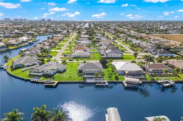 Aerial perspective of suburban area featuring a large body of water