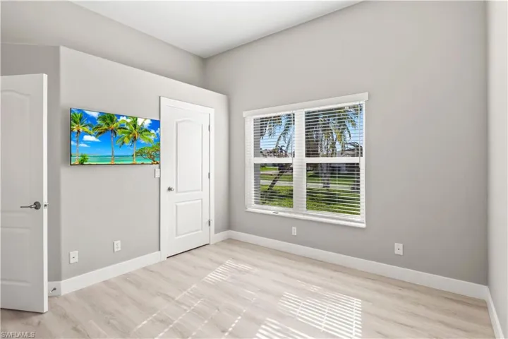 Unfurnished bedroom featuring baseboards and light wood-type flooring