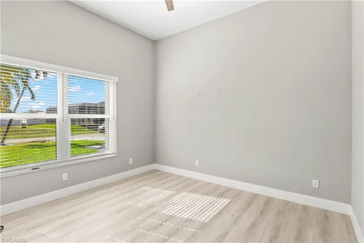 Unfurnished room with light wood-type flooring and a ceiling fan