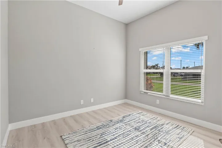 Spare room with baseboards and light wood-style flooring