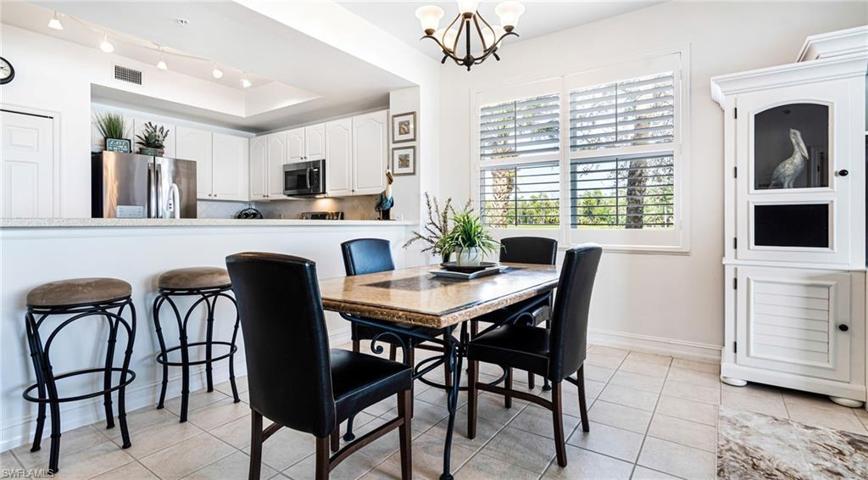 Dining area with tile floors and plantation shutters