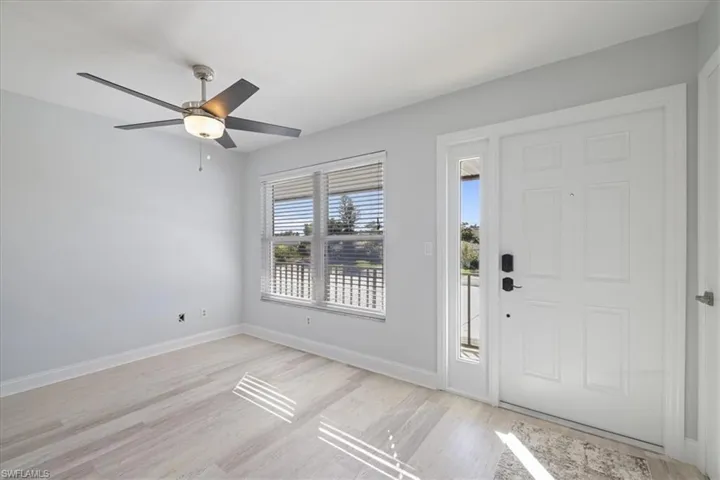 YEntryway with a ceiling fan and light wood finished floors