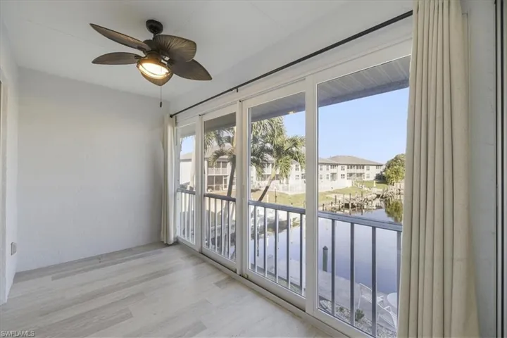 Unfurnished sunroom featuring a water view