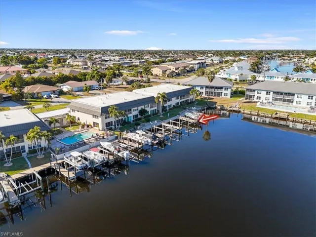 Aerial perspective of suburban area featuring a large body of water