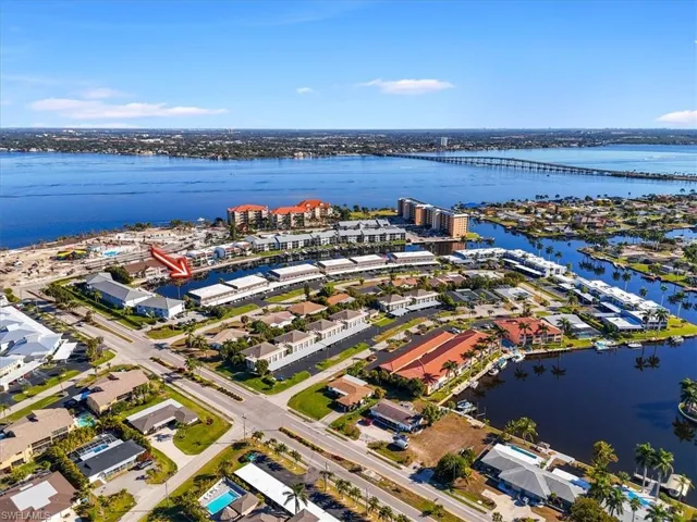 Aerial perspective of suburban area featuring a notable bridge and a nearby body of water