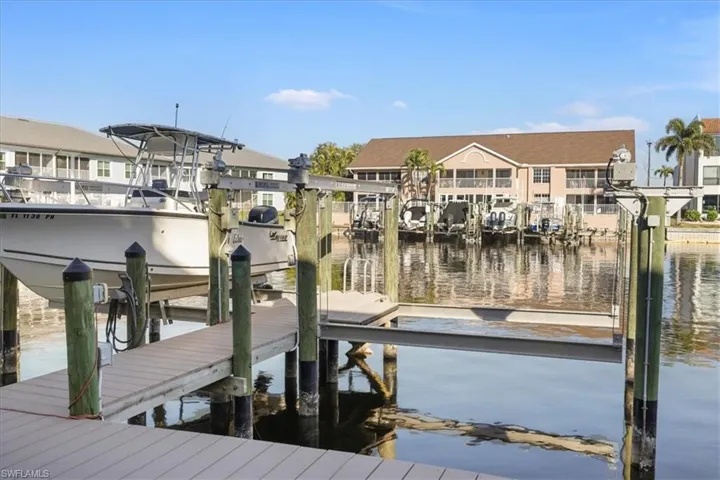 Dock area with a water view and boat lift