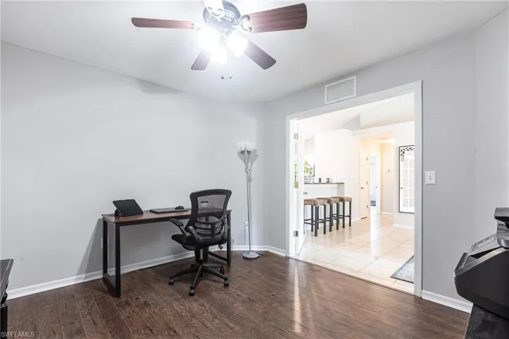 Office with wood finished floors and ceiling fan