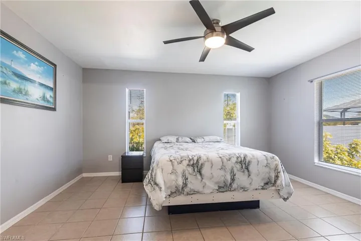 Bedroom featuring light tile patterned flooring and a ceiling fan