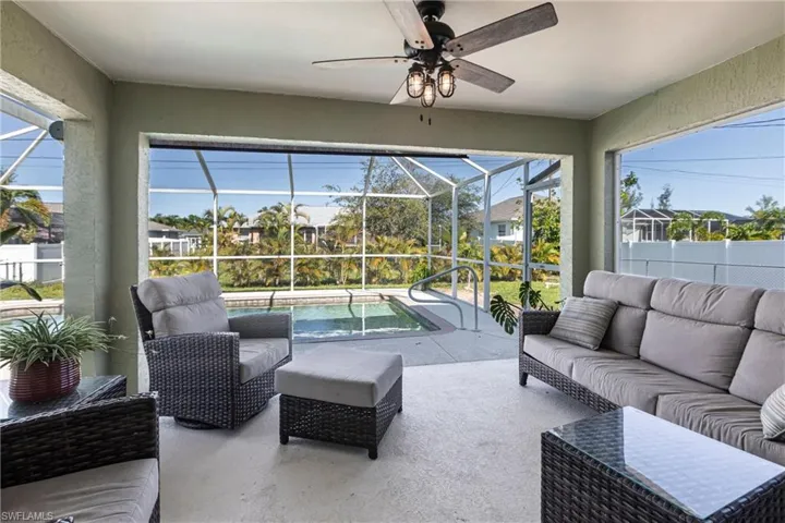 Sunroom / solarium featuring outdoor lounge area, a ceiling fan, and plenty of natural light