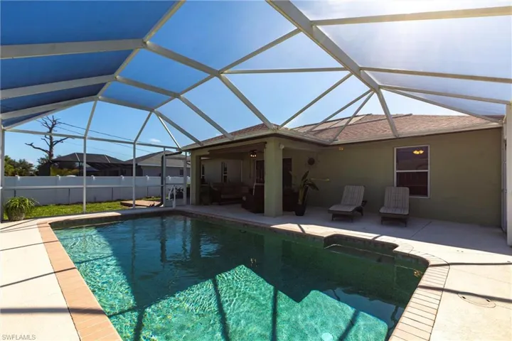View of pool with a patio area, outdoor lounge area, and a lanai