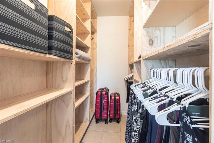 Walk in closet featuring light tile patterned flooring