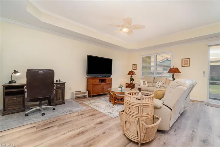 Large living area wood-style flooring, and a raised ceiling