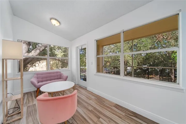 Sitting room featuring light hardwood / wood-style flooring and vaulted ceiling
