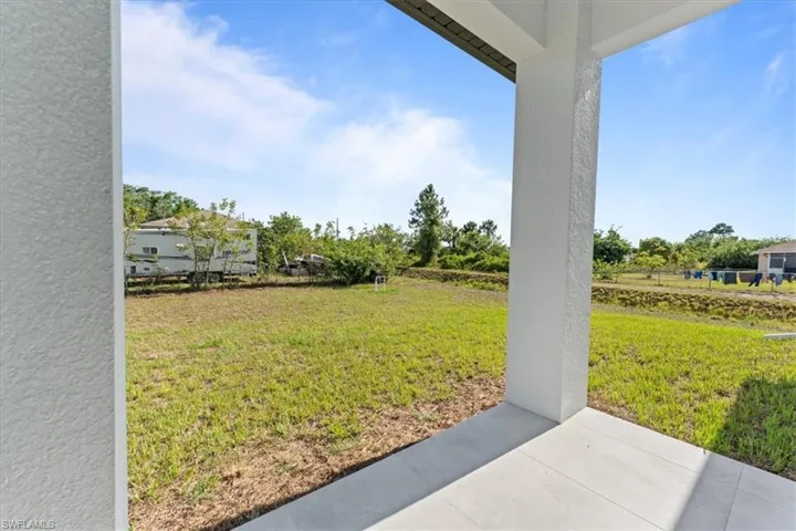 View of grassy yard with a patio