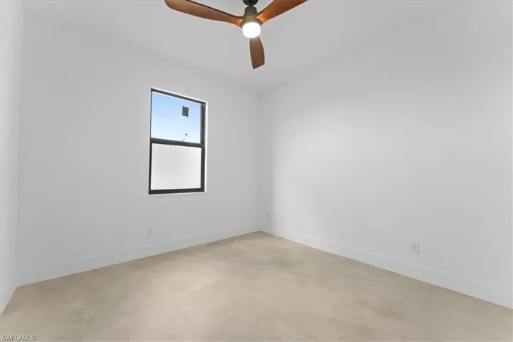 Room with ceiling fan and baseboards