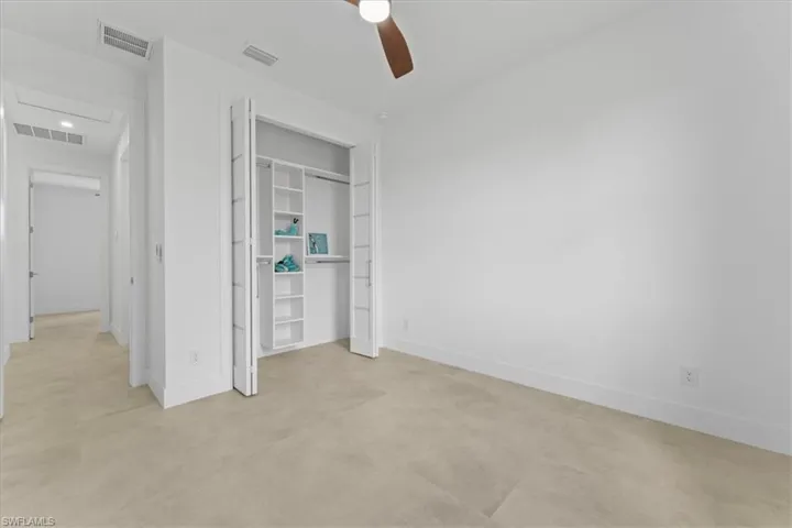 Bedroom with baseboards, a built out closet, ceiling fan, and recessed lighting