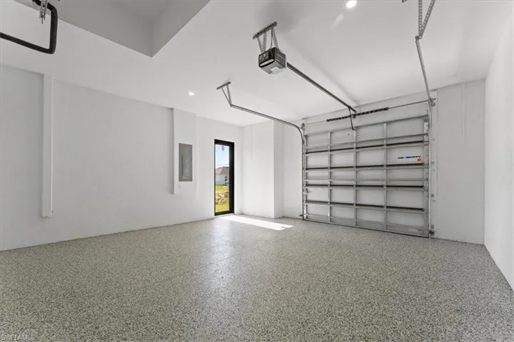 Garage with a garage door opener and electric panel