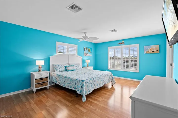 Coastal style primary bedroom -Virtually enhanced