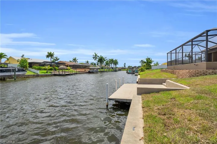 View of dock with glass enclosure and a water view
