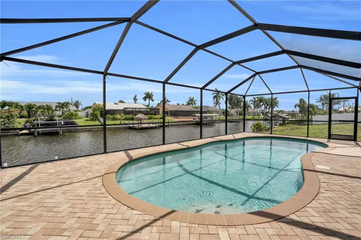 View of pool with a boat dock, a lanai, and a patio