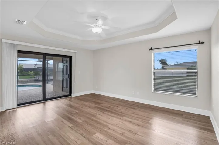 Unfurnished room featuring hardwood / wood-style flooring and a raised ceiling