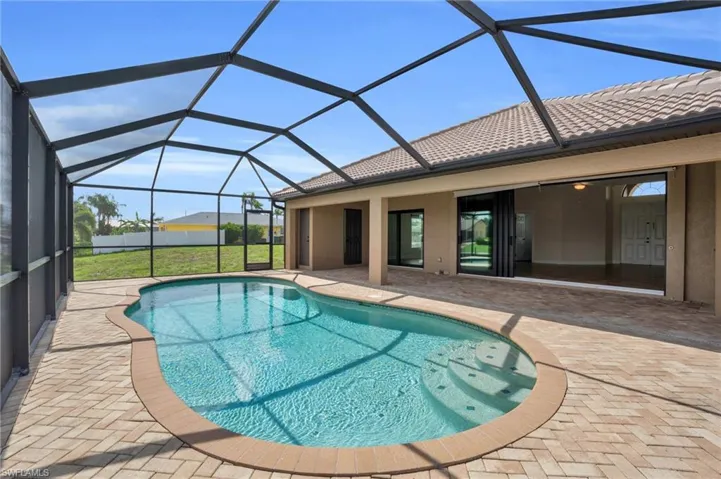 View of swimming pool with a patio and glass enclosure