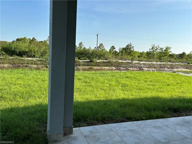 View of grassy yard and canal
