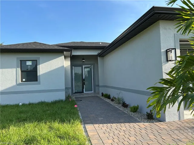 Entrance to property with stucco siding