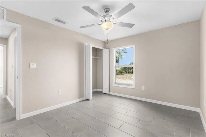 Unfurnished bedroom with a closet and ceiling fan