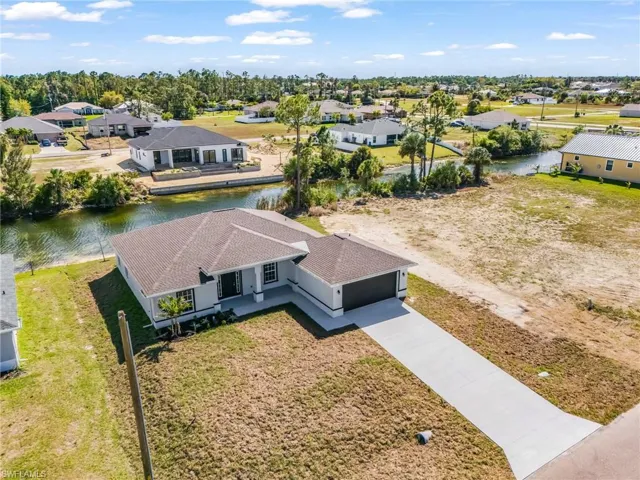 Aerial perspective of suburban area with a nearby body of water