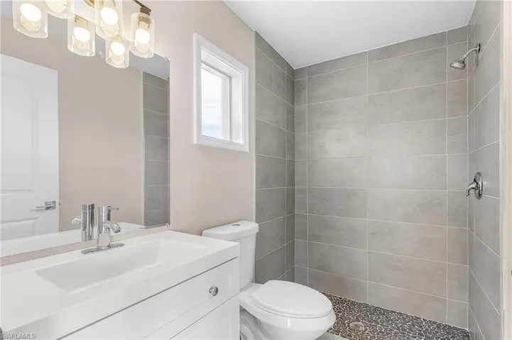 Full bathroom featuring vanity and a shower stall