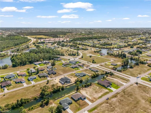 Aerial perspective of suburban area featuring a large body of water