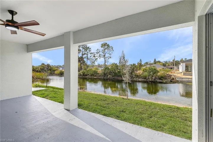 View of patio featuring ceiling fan and a water view