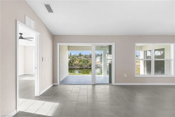 Spare room featuring a water view and ceiling fan