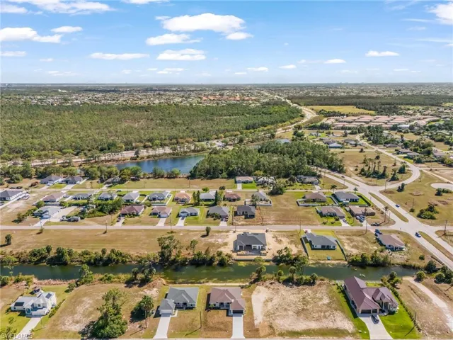 Aerial perspective of suburban area featuring a large body of water