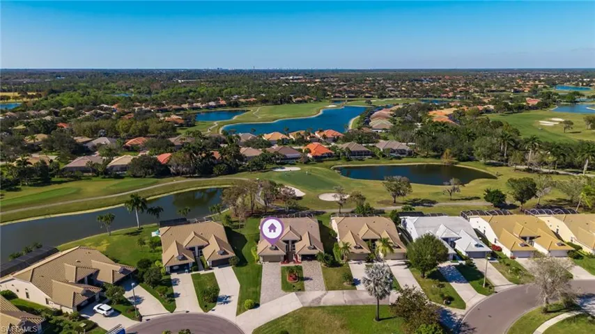 Aerial perspective of suburban area with a local golf course and a large body of water
