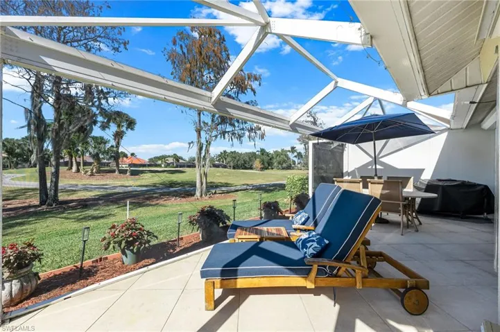 View of patio with a lanai, a sunroom, area for grilling, and outdoor dining space