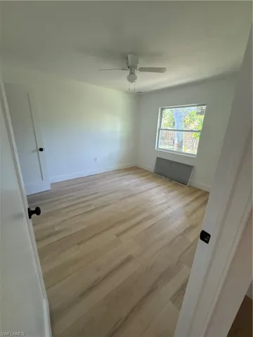 Unfurnished bedroom featuring light wood-style flooring and ceiling fan