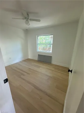 Unfurnished room featuring light wood-type flooring and ceiling fan