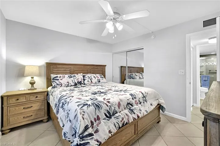Bedroom featuring baseboards, visible vents, a closet, and light tile patterned floors