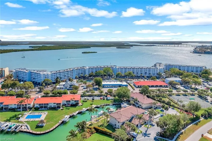 Aerial view featuring a water view and a view of city