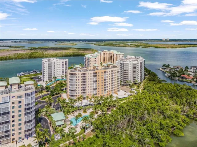 Bird's eye view of apartment complex and a nearby body of water