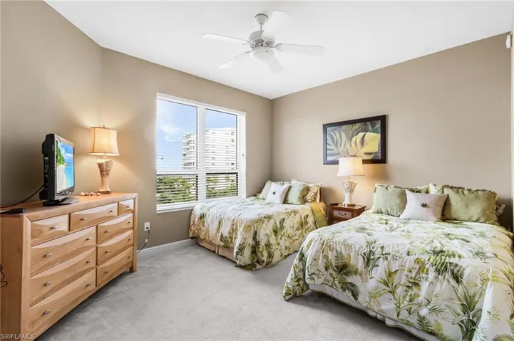 Bedroom with light colored carpet and ceiling fan