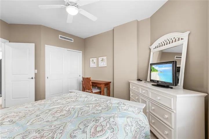 Bedroom with a ceiling fan and a closet