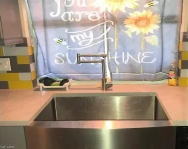 Kitchen view of light countertops and a sink