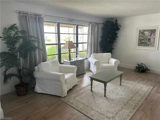 Living room featuring hardwood / wood-style flooring and a textured ceiling