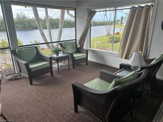 Sunroom / solarium with a water view