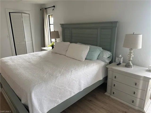 Bedroom featuring a closet and dark wood-type flooring